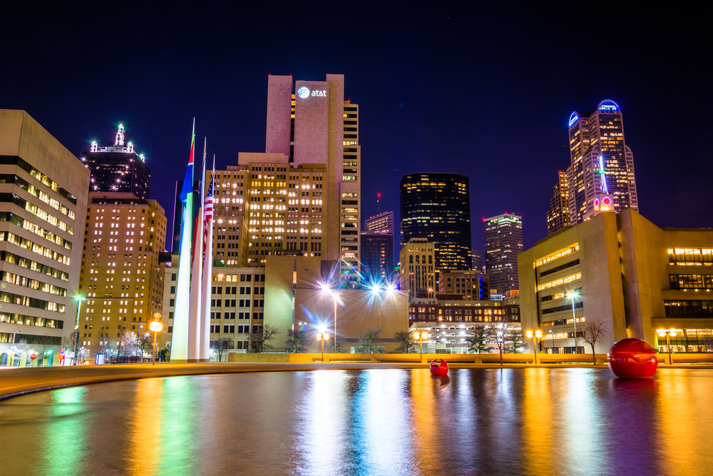 The Dallas skyline and the reflecting pool at City Hall at night, in Dallas, Texas. The Dallas skyline and the reflecting pool at City Hall at night, in Dallas, Texas.